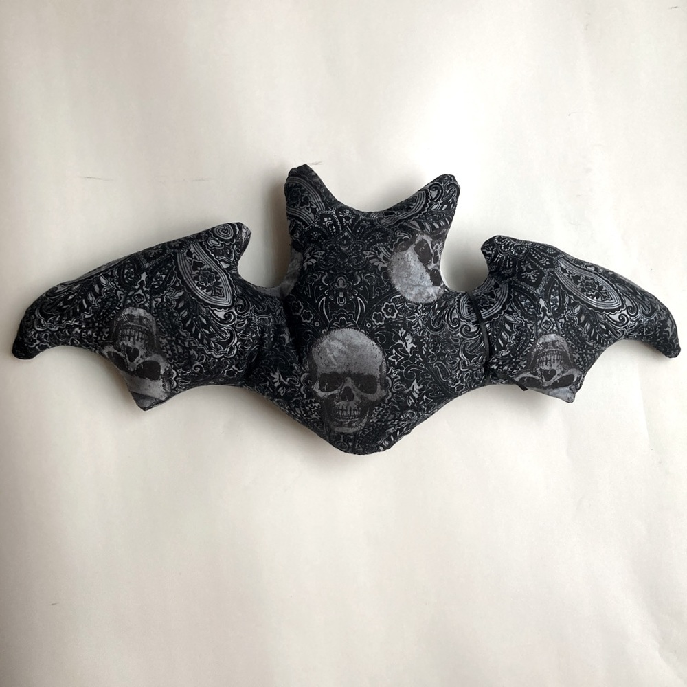 Grey skull and paisley bat shaped pillow